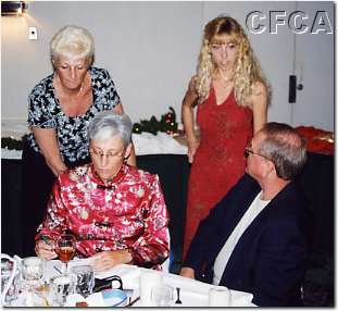 003.Pat and Shelley confer over costs as Jon prepares party.JPG