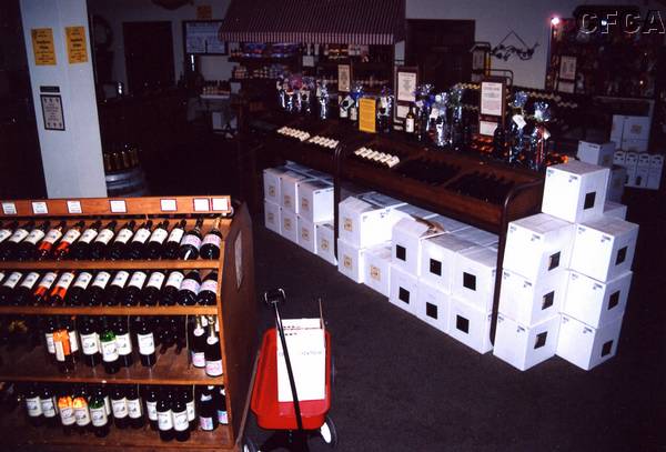 033.Meanwhile, inside, the little red wagons helped shoppers get their vino loaded.JPG