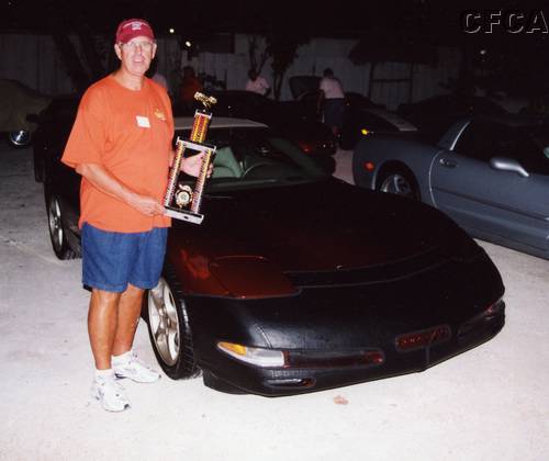 083.Larry with his trophy and Corvette, a happy camper heading home to Bonnie.JPG