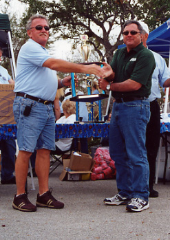 034.Phil accepting the 'Longest Distance Driven' trophy, which he will mail to Tony and Marie.JPG