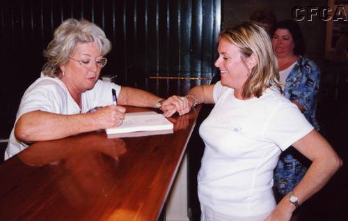 087.Cindi gets Paula's autograph in a cookbook.JPG