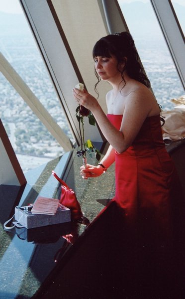 079.Reflecting on the days events, Tracy contemplates a wedding rose.JPG
