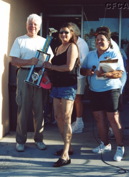 043.Barbara accepts her and Ken's C4 trophy from Dave.JPG