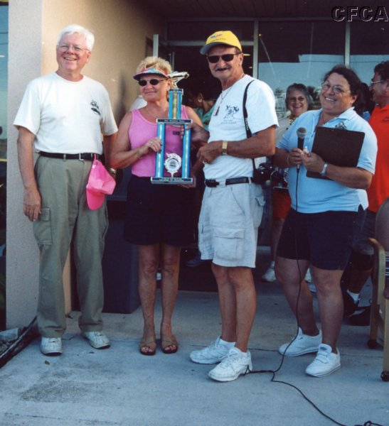 054.Arlene and Duane accept their Best in Show trophy from Dave and Marie for their C6 Mallett.JPG